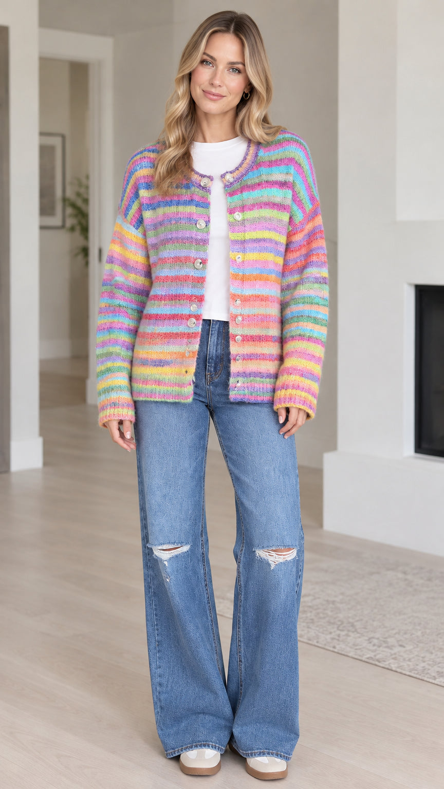 Front full view of woman wearing Rainbow Multi striped button-front knit cardigan with wide leg jeans