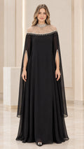 Front view of black pearl-embellished illusion neckline cape evening maxi dress