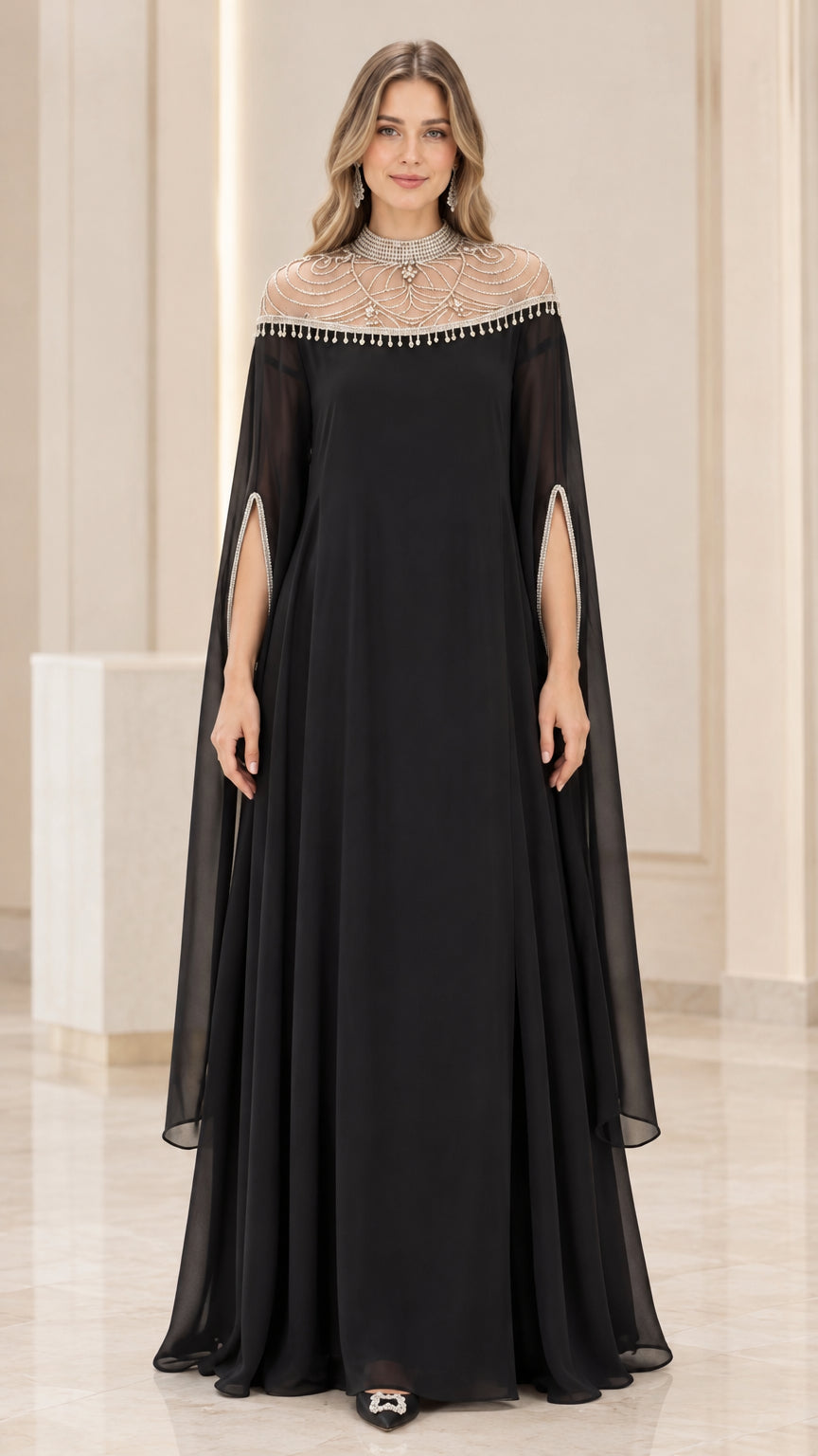 Front view of black pearl-embellished illusion neckline cape evening maxi dress