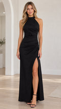 Front view of model wearing black halter neck ruched maxi dress with side slit