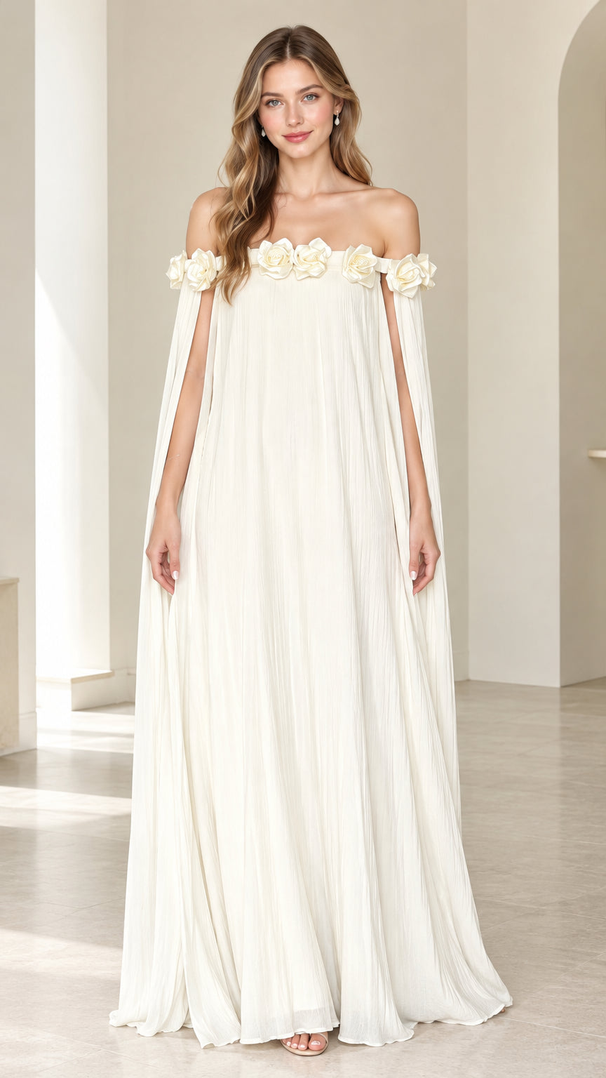 Model wearing Ivory off-the-shoulder pleated maxi dress with floral rosette trim and cape sleeves front view