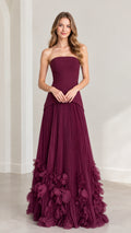 Front view of model wearing burgundy strapless pleated maxi dress with 3D petal hem