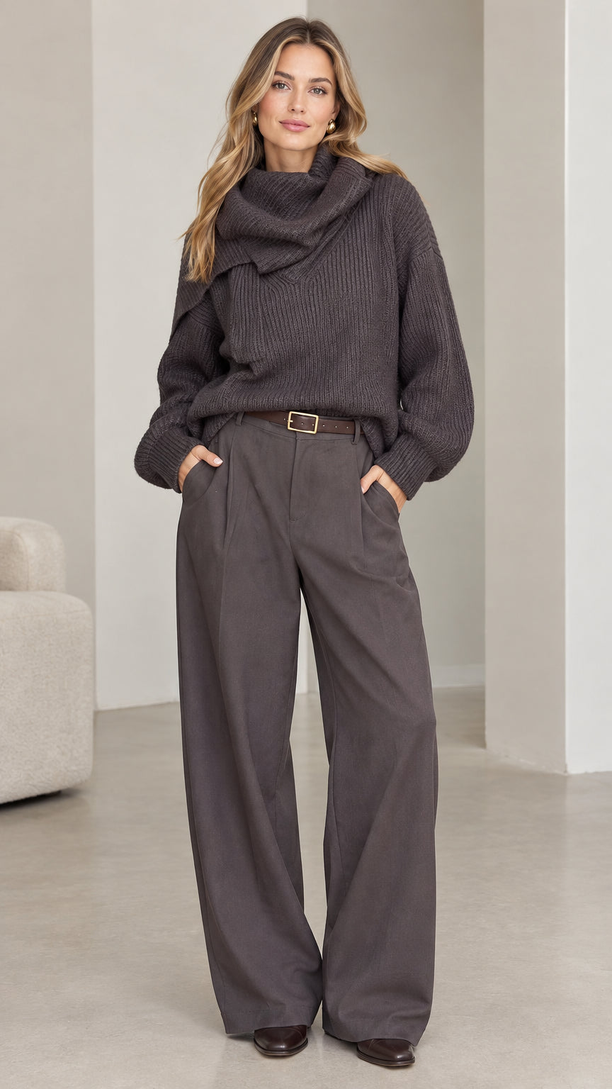 Full front view of model wearing charcoal grey ribbed cowl neck sweater with matching tailored wide-leg trousers