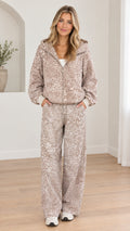 Front full view of woman wearing taupe leopard print hooded jacket and wide-leg pants set