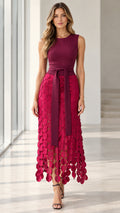 Model wearing Berry Red sleeveless midi dress with textured petal skirt and tie waist belt - front view