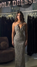 Front view of model wearing silver asymmetrical one-shoulder beaded evening gown