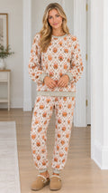 Full front view of model wearing cream pumpkin print sweatshirt and jogger pants set