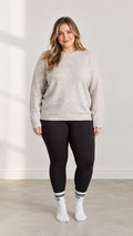 Front full-length view of model wearing Light Grey plus size crewneck knit sweater