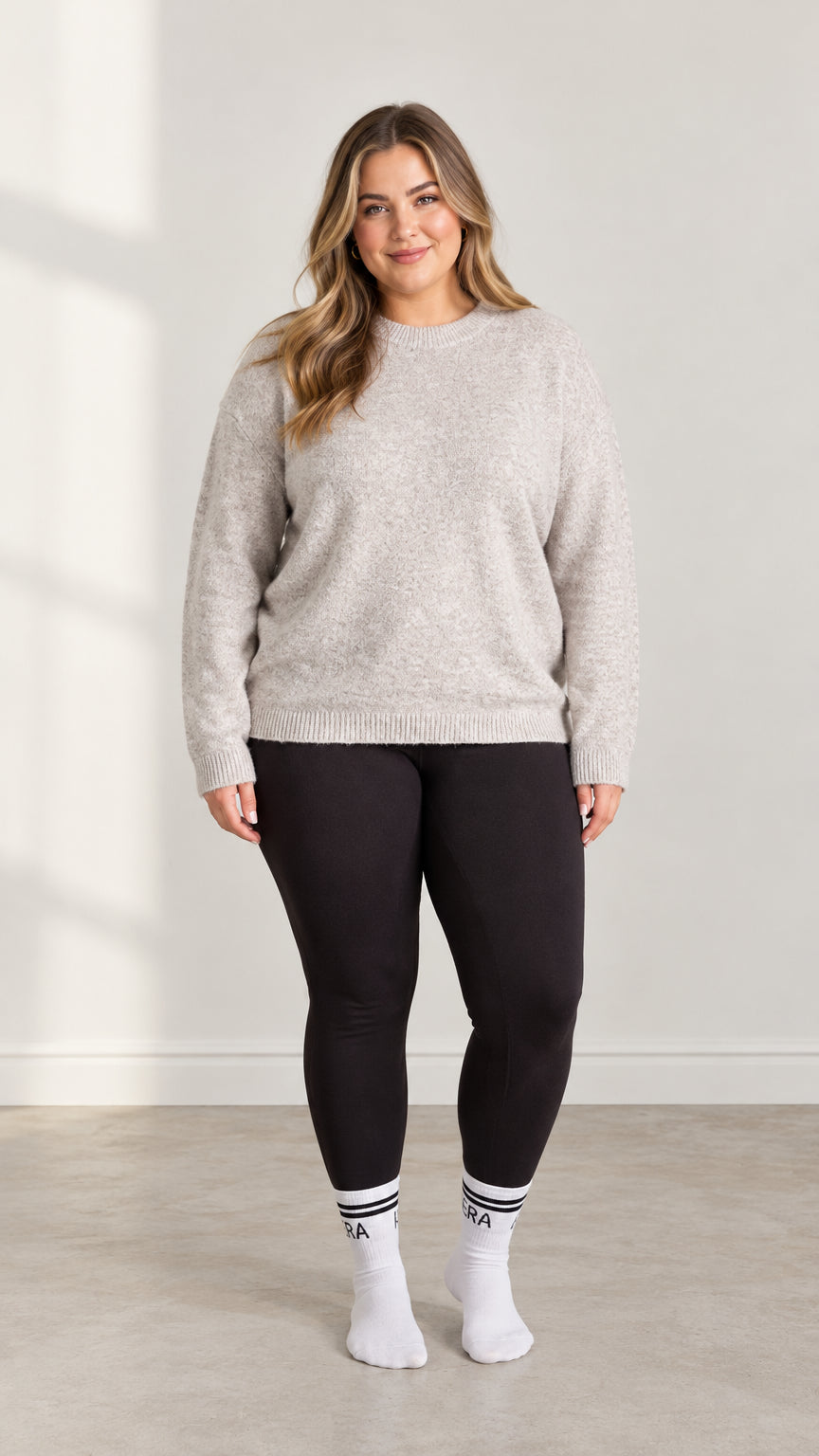 Front full-length view of model wearing Light Grey plus size crewneck knit sweater