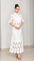 Full front view of model wearing white floral lace collared top and maxi skirt set