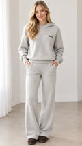 Front view of model wearing heather gray fleece hoodie and wide-leg lounge pants set