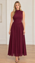 Full front view of model wearing burgundy sleeveless mock neck pleated maxi dress