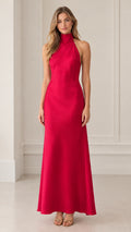Front view of model wearing fuchsia halter neck backless maxi dress