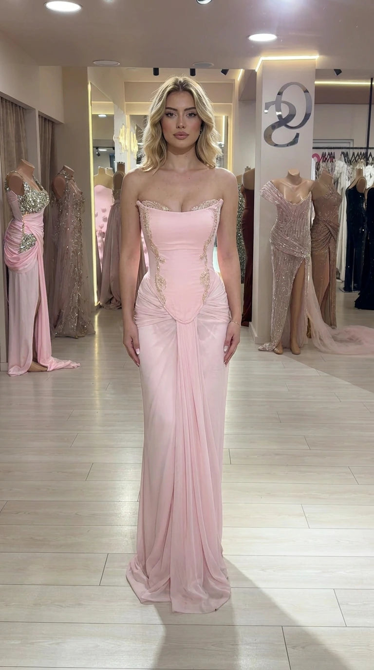Front full view of woman wearing Light Pink strapless corset evening gown with gold embroidery