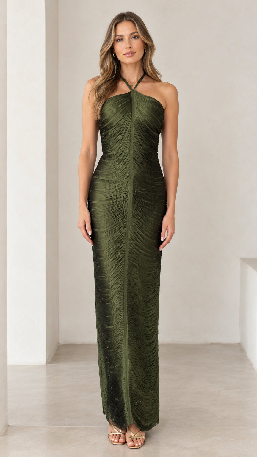 Front full-length view of woman wearing olive green halter ruched maxi dress