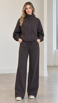 Front full view of woman wearing charcoal zip-up track jacket and matching wide-leg pants set