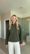 Model wearing army green half-zip sherpa fleece pullover sweatshirt front view