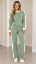 Front full view of woman wearing sage green crewneck sweatshirt and wide leg sweatpants set with white side stripes