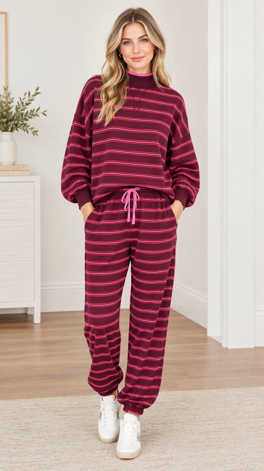 Full front view of woman wearing burgundy striped sweatshirt and matching jogger pants loungewear set