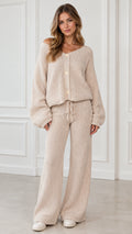 Front view of model wearing beige ribbed knit button cardigan and wide leg lounge pants set