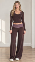 Front full view of woman wearing brown long sleeve crop top and wide leg lounge pants set with plaid trim
