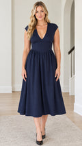 Front view of model wearing Navy Blue deep V-neck cap sleeve midi dress