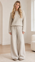 Front full view of woman wearing oatmeal knit sweater and wide-leg lounge pants set