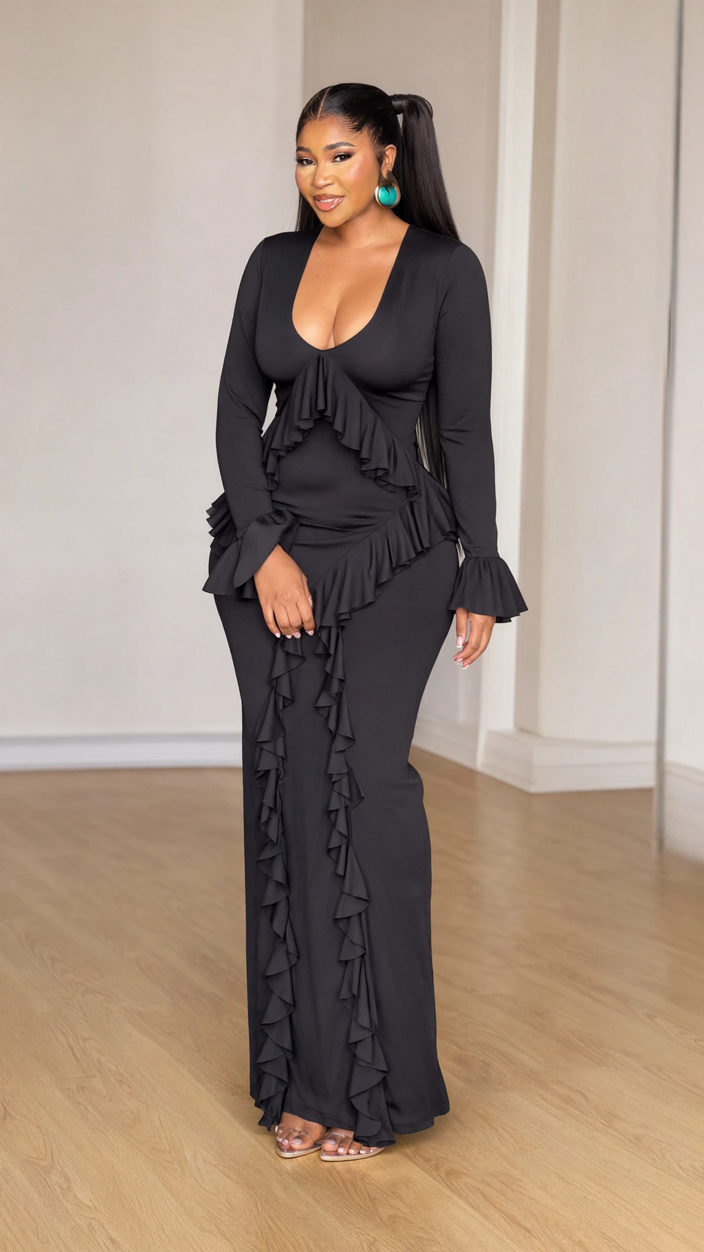 Front view of model wearing black scoop neck long sleeve maxi dress with cascading ruffles