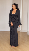 Front view of model wearing black scoop neck long sleeve maxi dress with cascading ruffles
