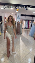 Model wearing Champagne sweetheart rhinestone gown with feather-trimmed high slit front view