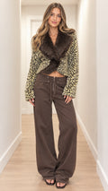 Full front view of model wearing olive khaki leopard print cropped knit jacket with faux fur collar and wide-leg brown pants