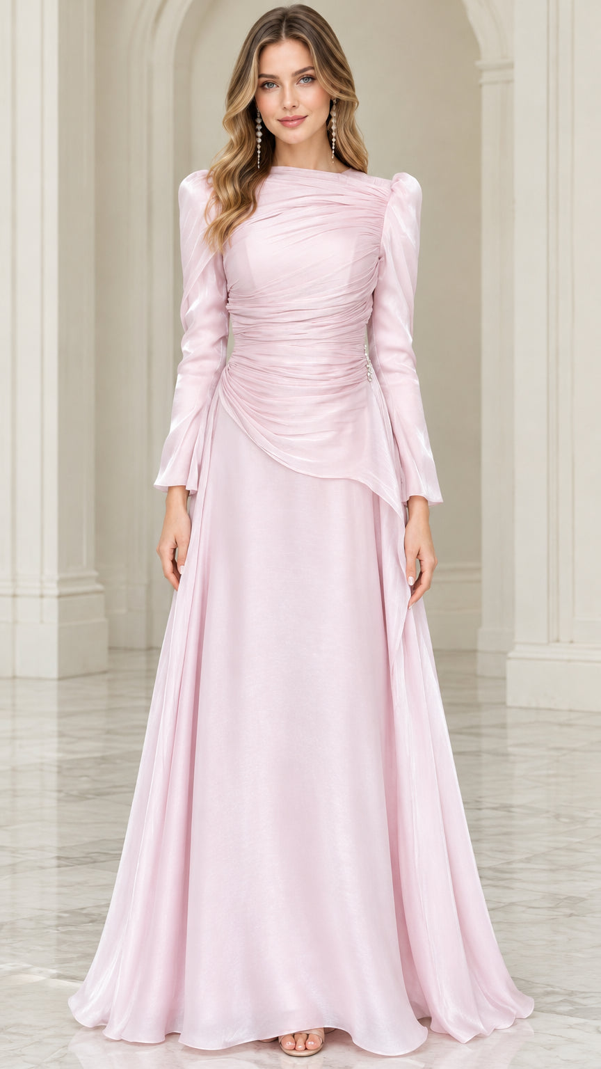 Front view of woman wearing blush pink long sleeve ruched evening gown with beaded waist accent