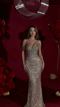 Front view of model wearing a champagne sequin beaded mermaid evening gown with sweetheart neckline