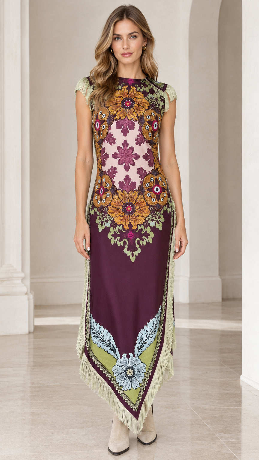 Front full view of woman wearing plum vintage floral print sleeveless maxi dress with fringe trim and handkerchief hem