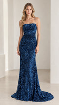 Front view of model wearing a royal blue sequined mermaid gown with spaghetti straps