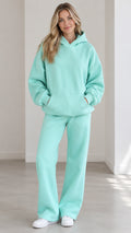 Front full view of woman wearing Mint Green oversized hoodie and wide-leg sweatpants set