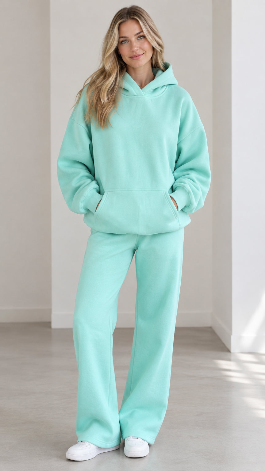 Front full view of woman wearing Mint Green oversized hoodie and wide-leg sweatpants set
