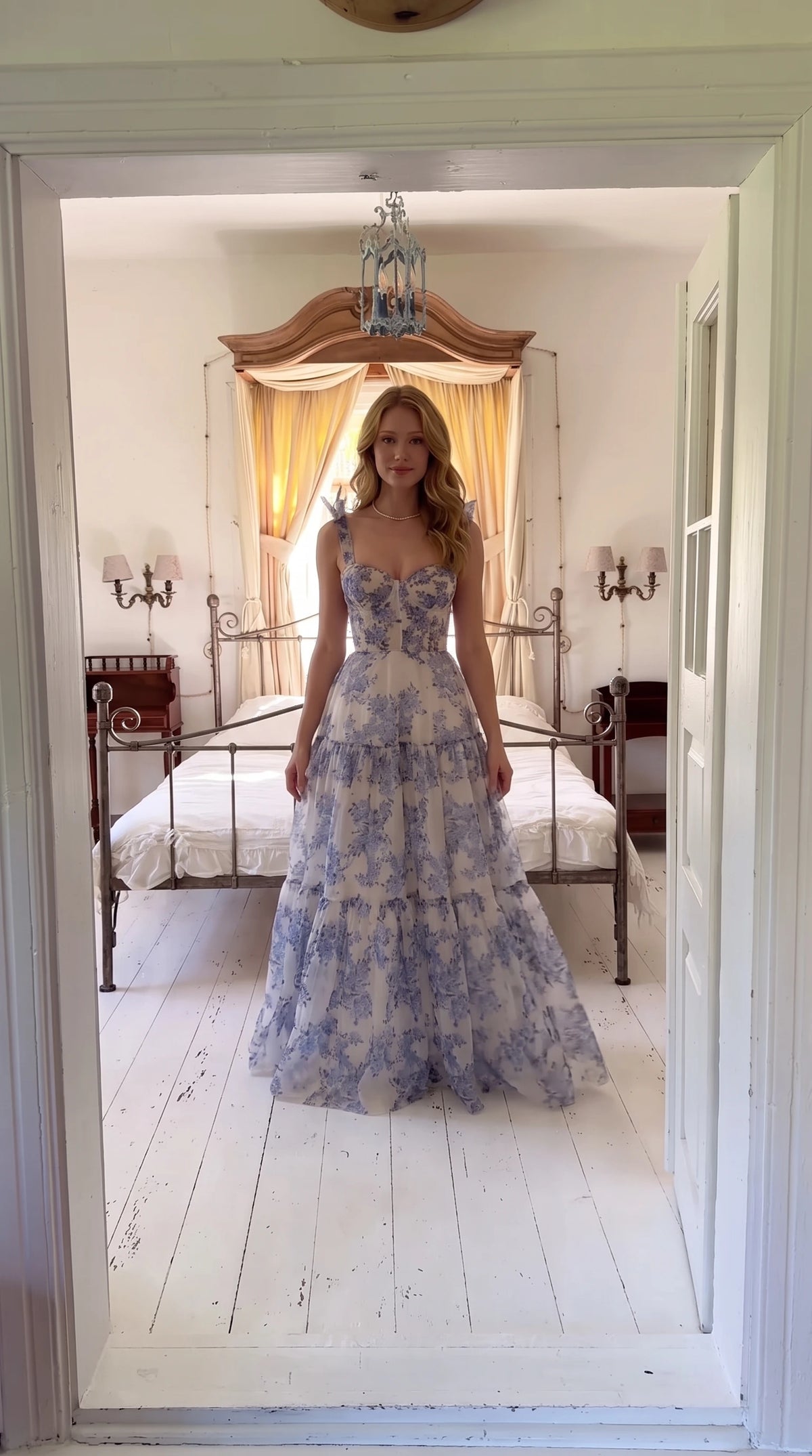 Front view of woman wearing blue and white floral corset maxi dress with tie straps