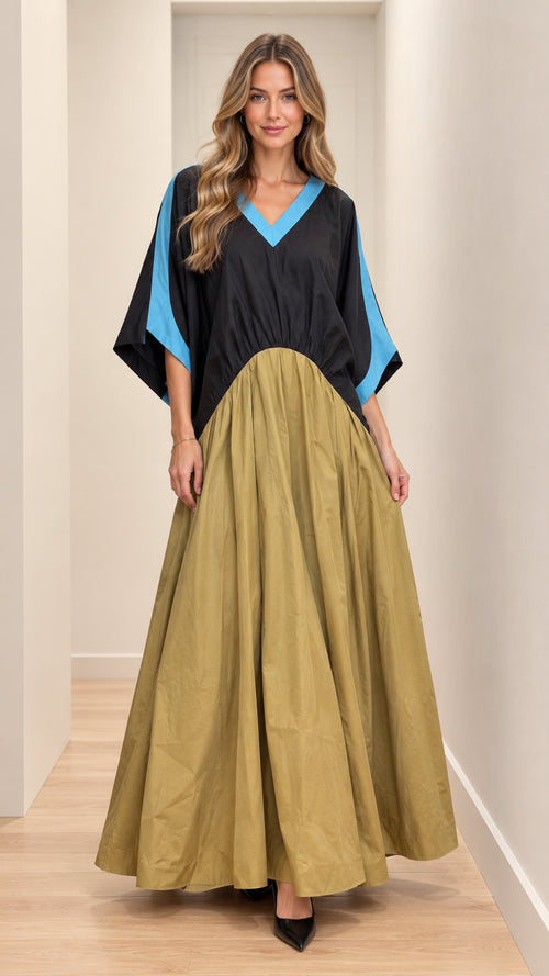 Front full-length view of model wearing black and khaki batwing maxi dress with blue contrast trim