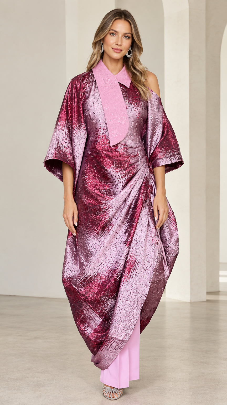Full front view of model wearing fuchsia pink metallic draped asymmetrical kaftan and matching pants set