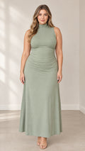 Front full-length view of woman wearing a sage green sleeveless mock neck maxi dress with side ruching