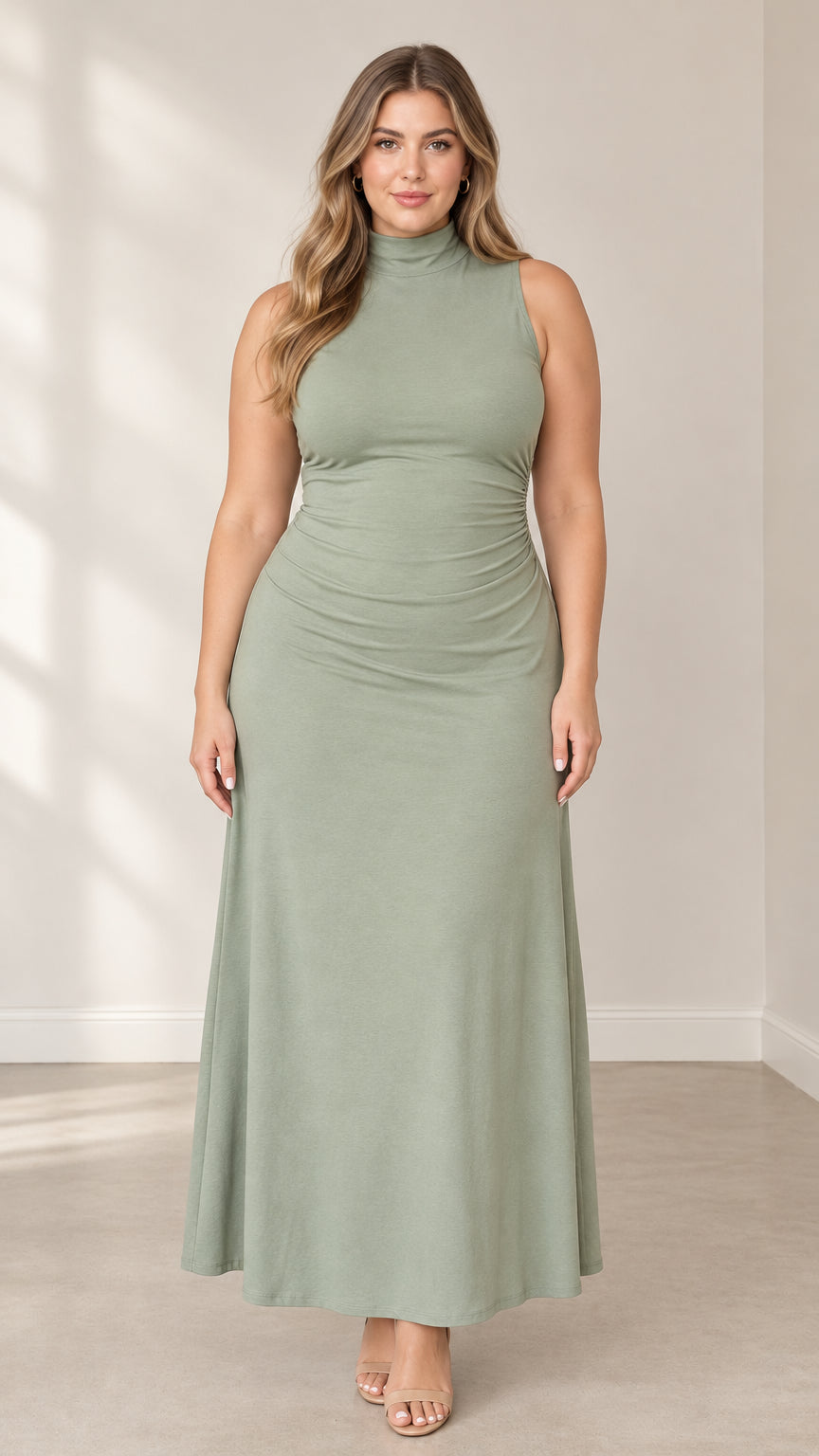 Front full-length view of woman wearing a sage green sleeveless mock neck maxi dress with side ruching