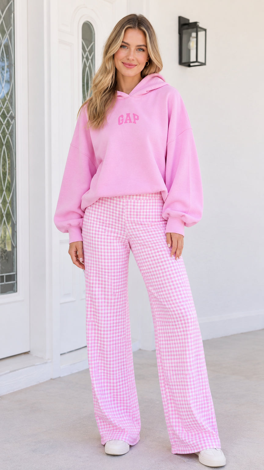 Front view of woman wearing pink hooded sweatshirt and pink gingham wide-leg pants set