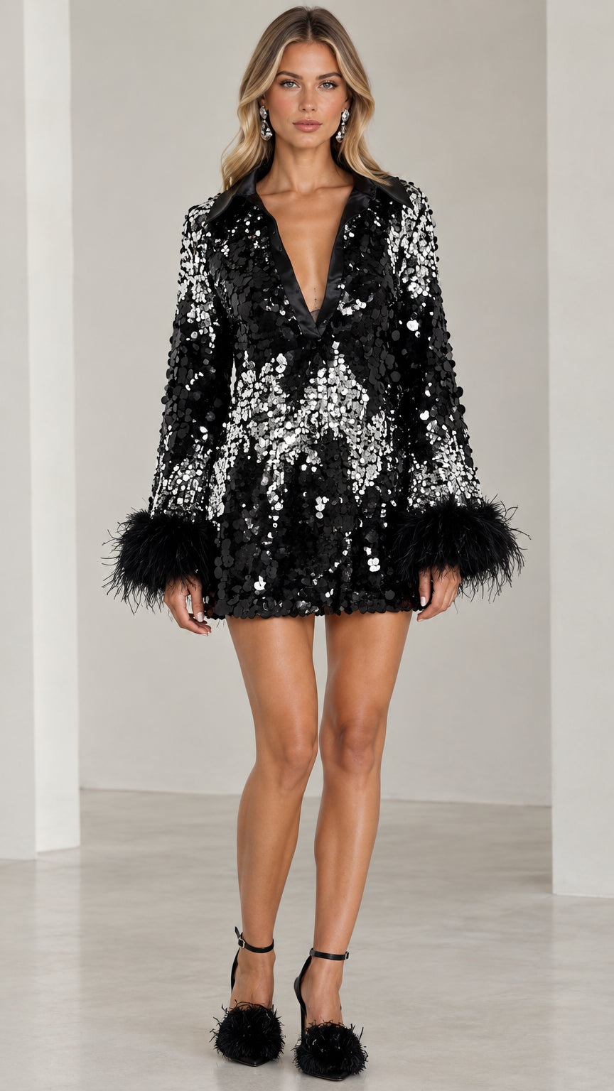 Front view of model wearing black sequined plunge mini dress with black feather cuffs