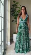 Front view of woman wearing emerald green floral print V-neck sleeveless maxi dress