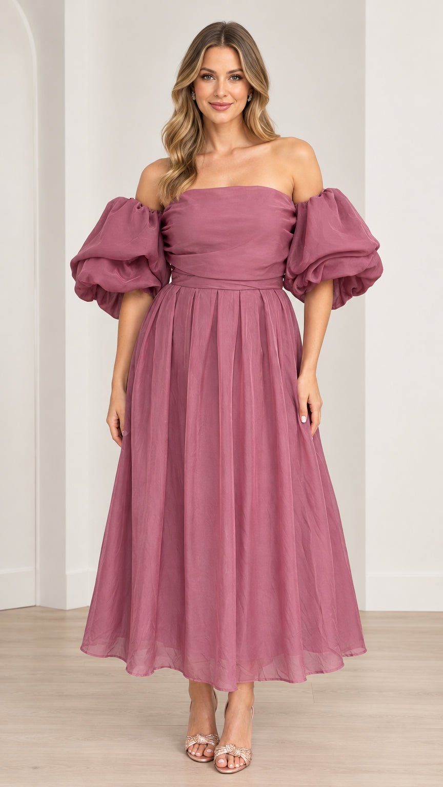 Front view of model wearing off-the-shoulder puff sleeve pleated midi dress in mauve