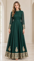 Front view of woman wearing emerald green long-sleeve embroidered maxi dress with matching belt