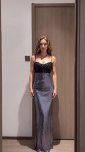 Front view of model wearing silver sequin maxi dress with black lace bustier bodice