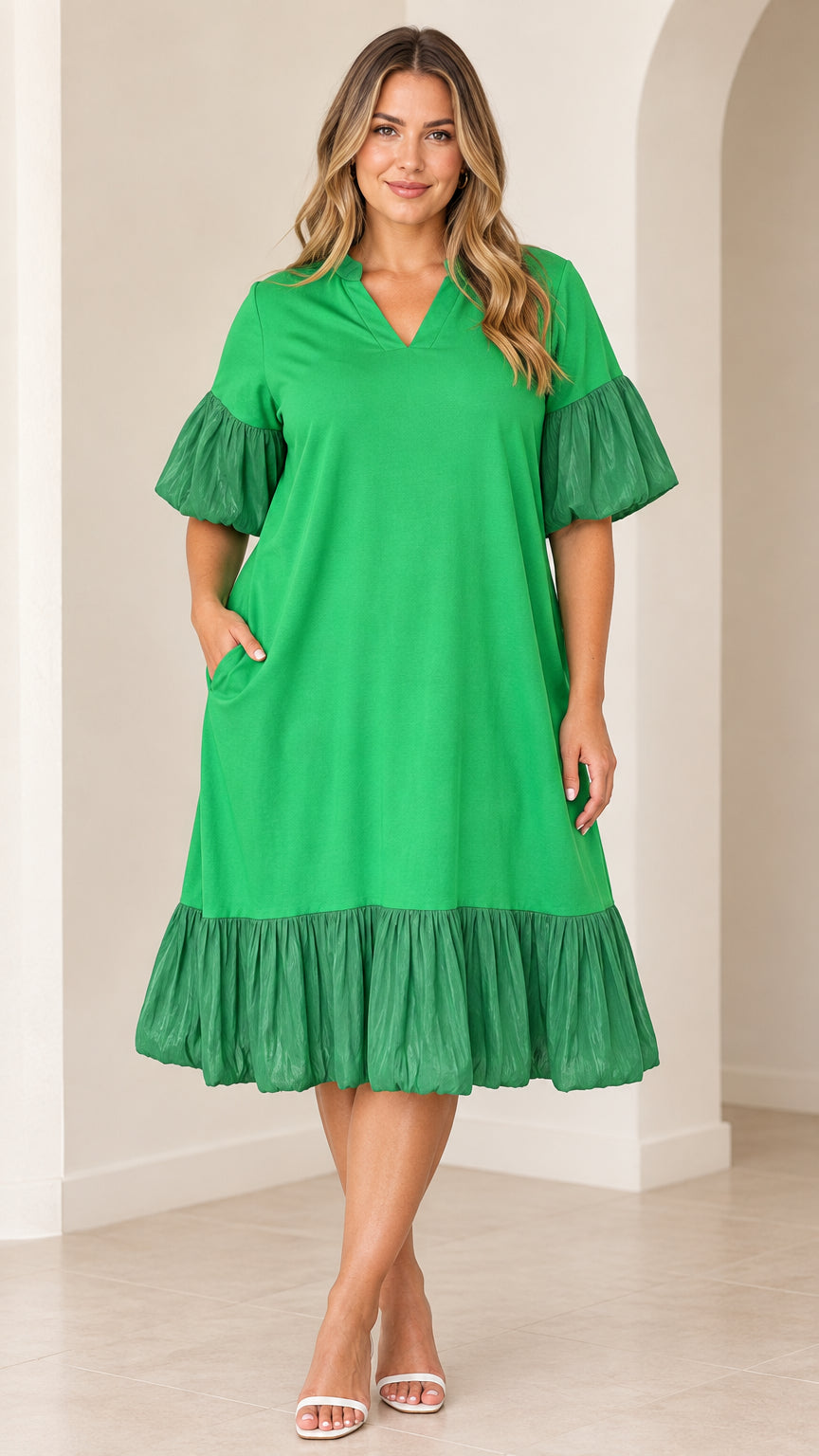 Front view of model wearing green V-neck flutter sleeve midi dress with tiered ruffle hem