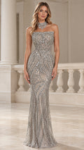 Front view of model wearing a silver strapless sequin mermaid evening gown in an architectural hall